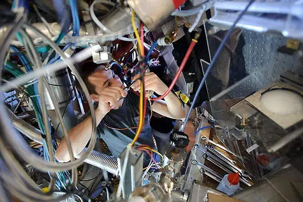 postdoc student performing maintenance on the HSX