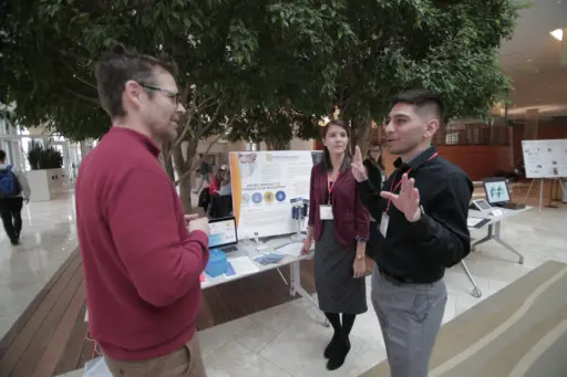 Members of Pathogenomica explain their technology during a poster session at the 2017 Transcend Madison Innovation Competition: Powered by Qualcomm. Pathogenomica is a startup that harnesses genetic sequencing techniques to rapidly detect pathogens in drinking water. Photo: Stephanie Precourt. 