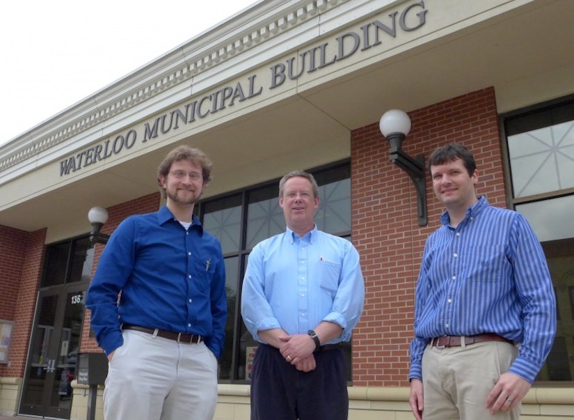 From left, Andrew Lewandowski, a pediatrician who heads the city’s renewable energy committee, city clerk-treasurer Mo Hansen, and Scott Williams, research and education coordinator at the Wisconsin Energy Institute, in front of Waterloo City Hall. Photo: David Tenenbaum