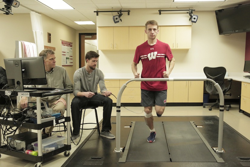 Darryl Thelen and Jack Martin watching student running on treadmill