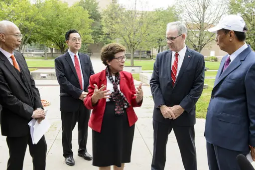 UW-Madison Chancellor Rebecca Blank (center) and College of Engineering Dean Ian Robertson (second from right) give Foxconn representatives, including Chairman Terry Gou (right), a tour of the engineering campus. 