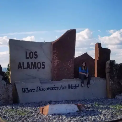 Mummah sitting on sign at Los Alamos