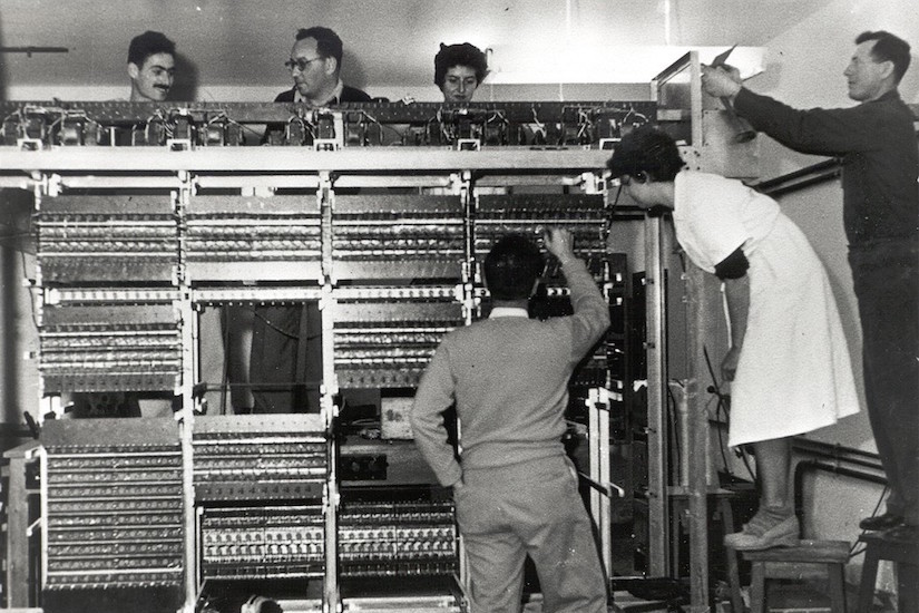Photo of Thelma Estrin working on supercomputer