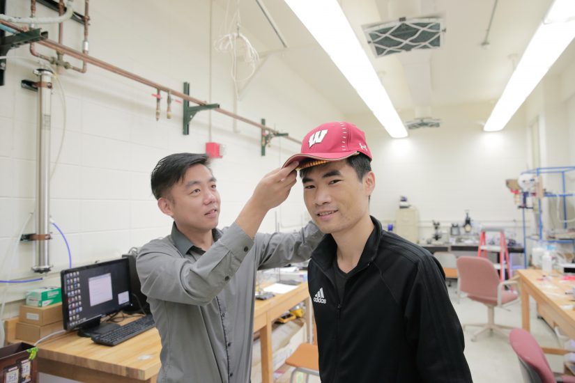 Photo of Xudong Wang and student in the lab