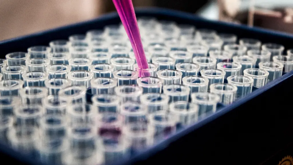 Close up of putting liquid into tray of vials