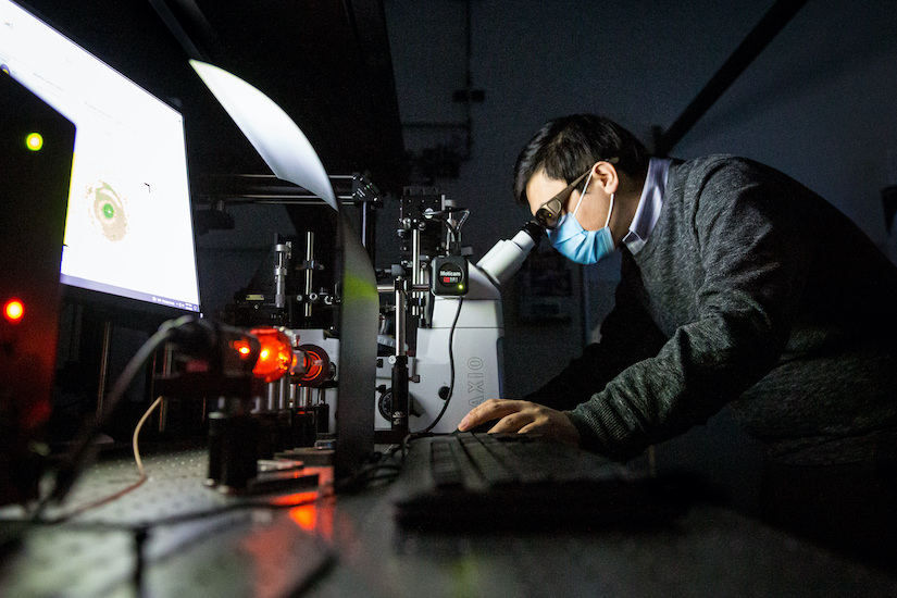 Photo of Jizhe Cai working in the lab