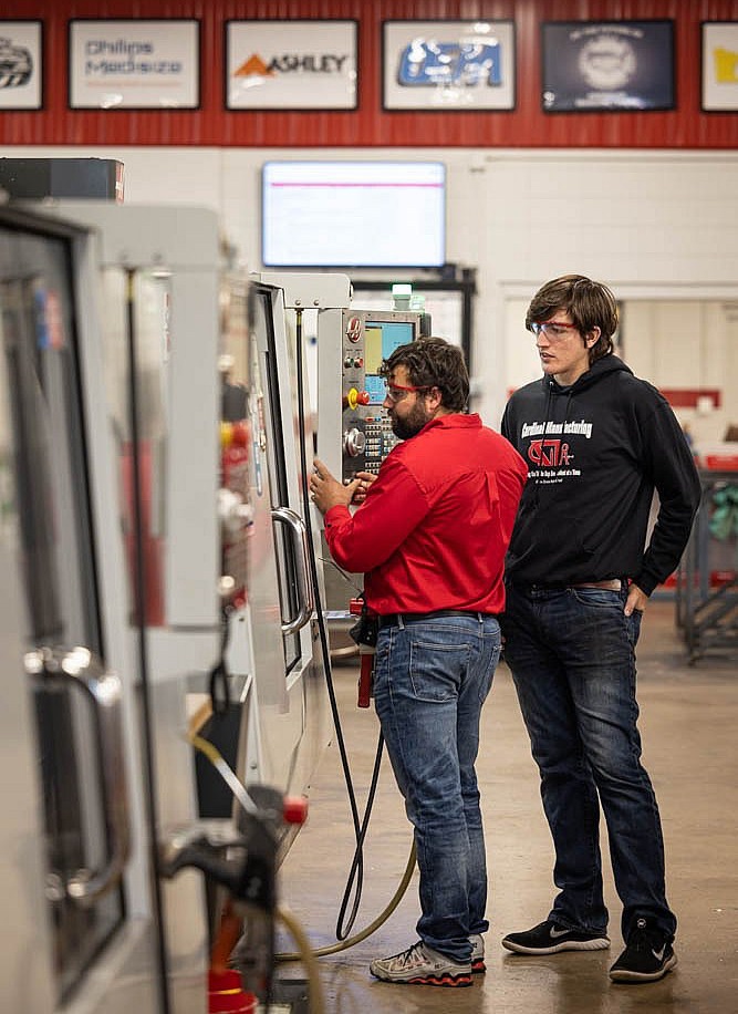 a Cardinal Manufacturing instructor and student operate a Haas CNC Machining Center