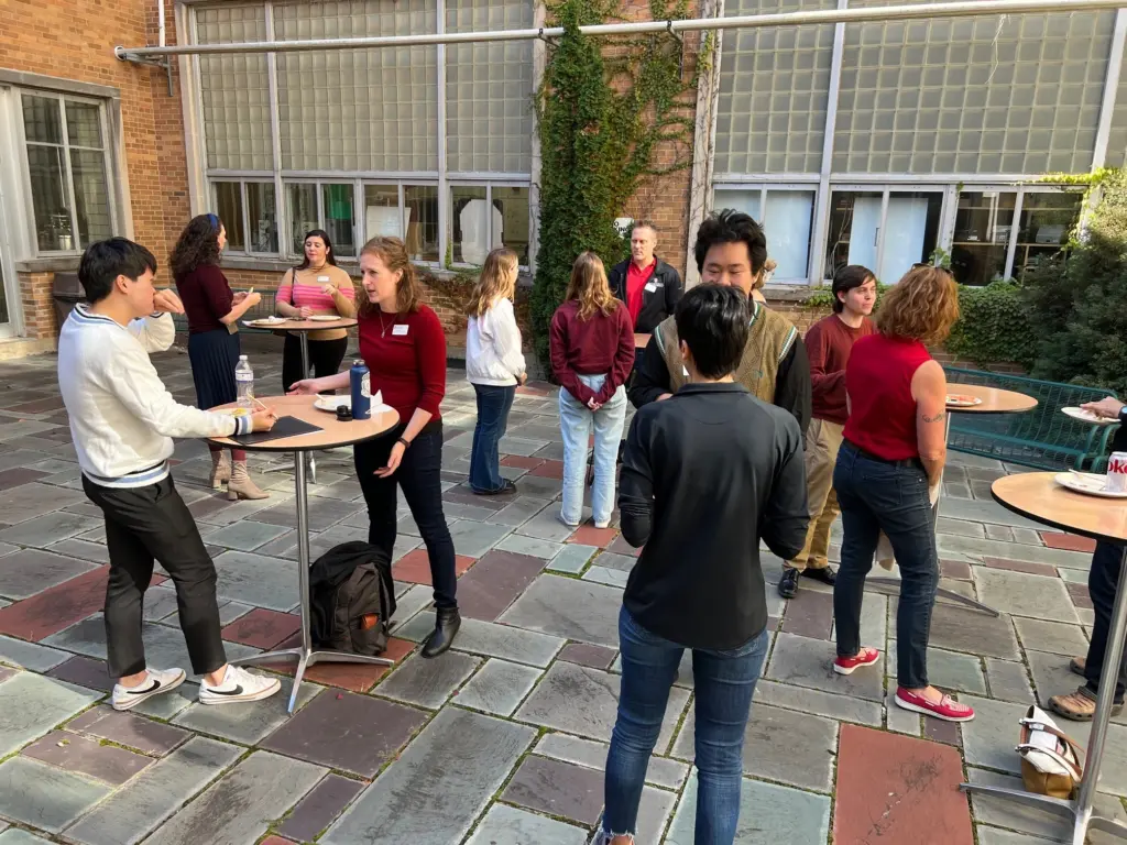 Students and guests talk while eating in the Engineering Hall courtyard