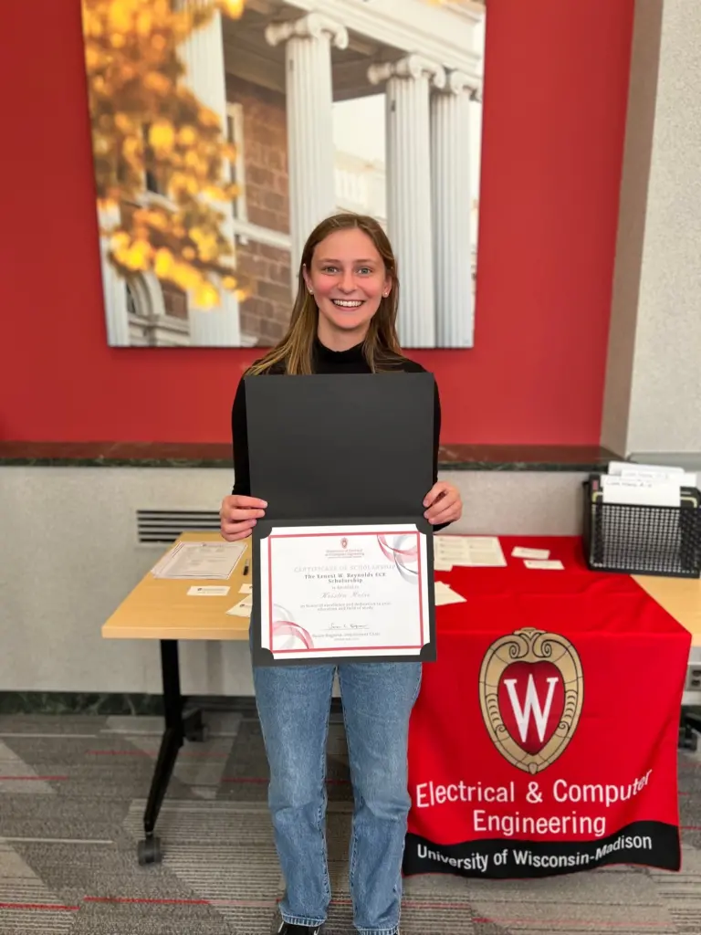 ECE student poses with scholarship certificate