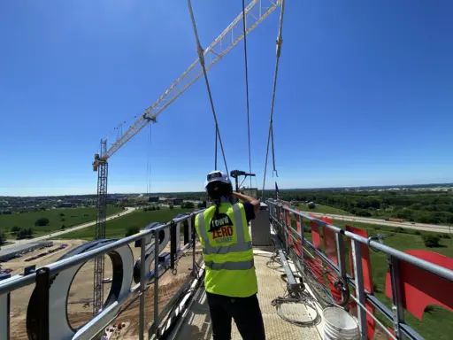 Woman on top of a tower crane.