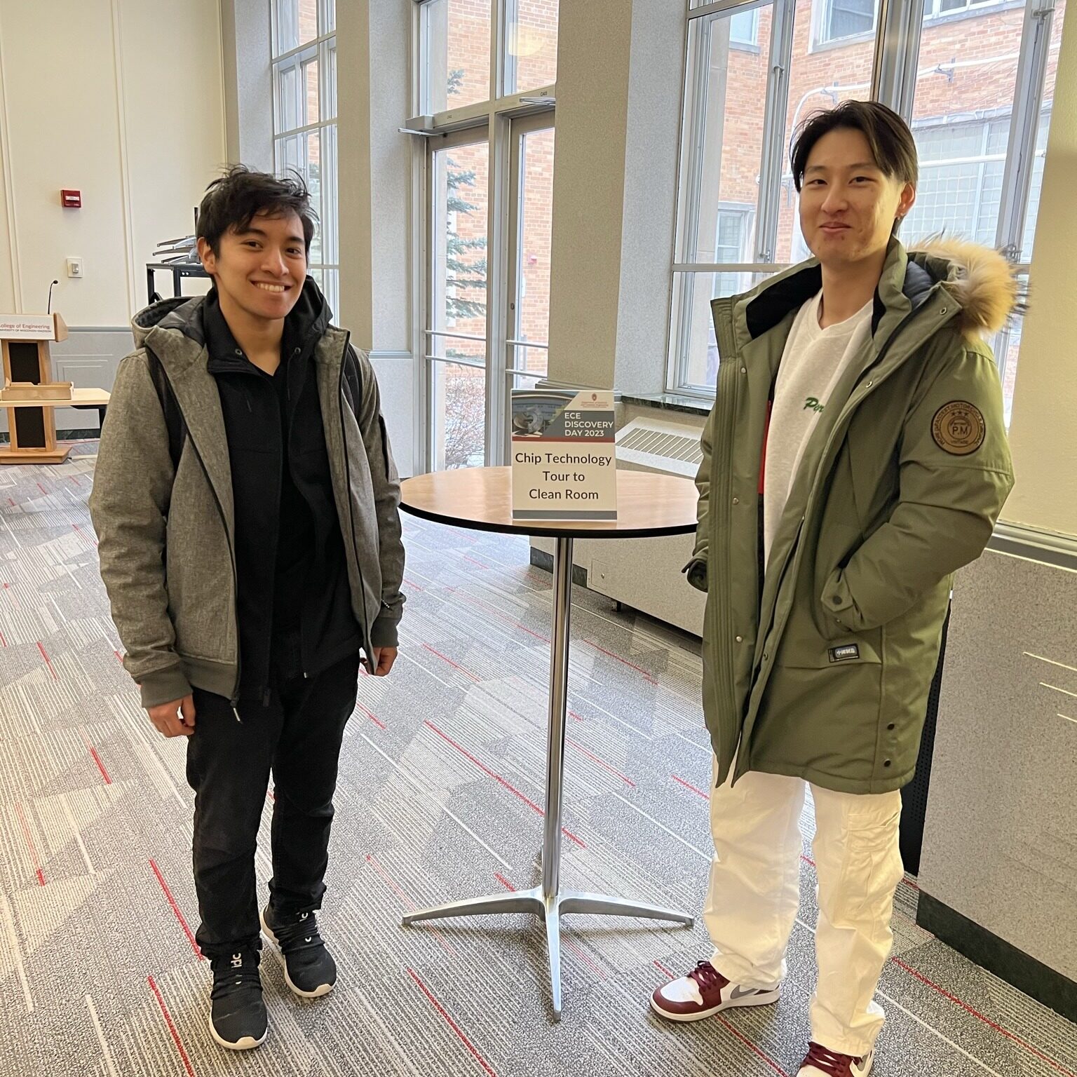 Jesus Perez and Timothy Shih standing by a tall table in the Cheney Room in Engineering Hall