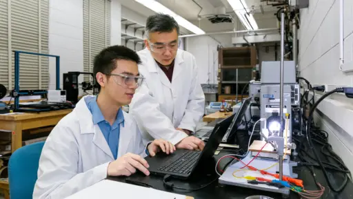 PhD student Yutao Dong and Professor Xudong Wang working in the lab