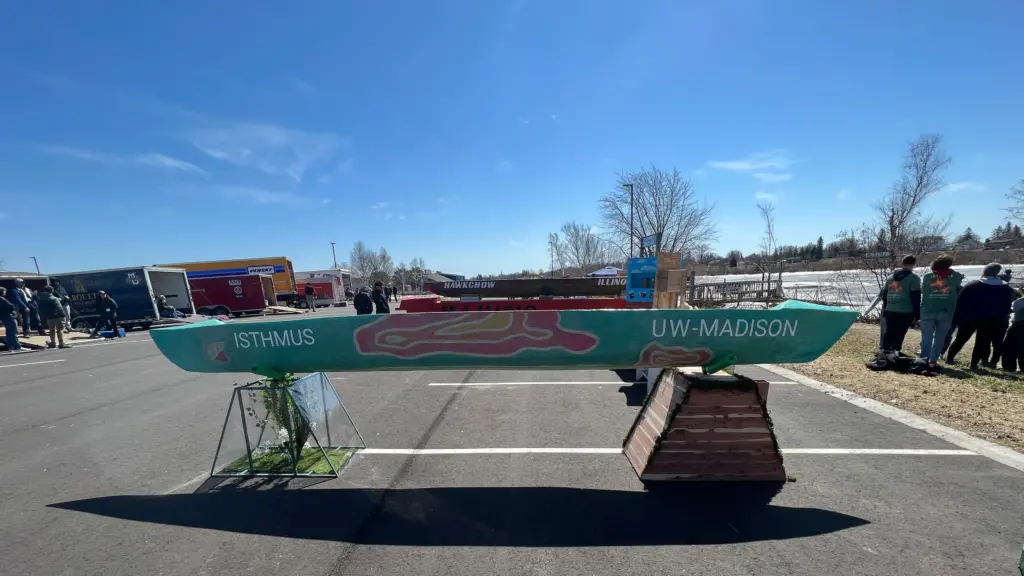 Isthmus, the 2023 UW-Madison Concrete Canoe, outside on a sunny day.