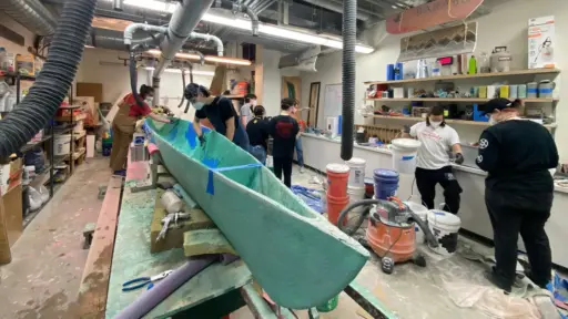Concrete Canoe team members work together on building their 2023 competition boat.