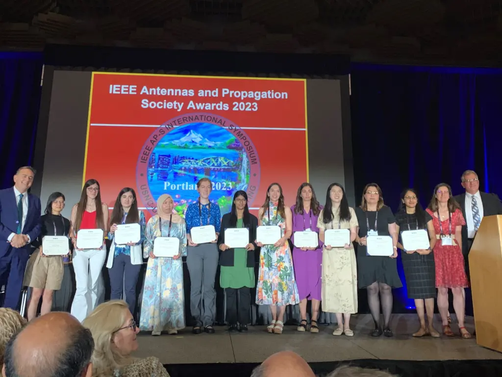 ECE Alum Audrey Evans on stage with group of award winners