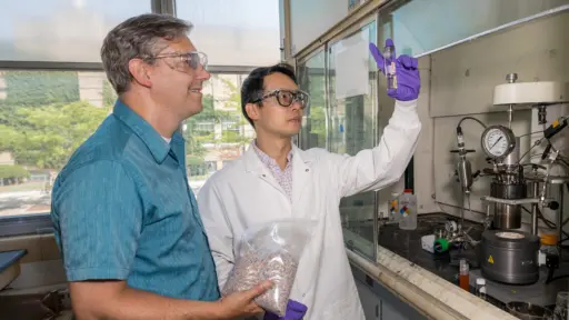 Professor George Huber and postdoctoral researcher Houqian Li working in lab