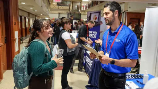A student talks with a recruiter at the fall 2023 Engineering & STEM Career Fair.