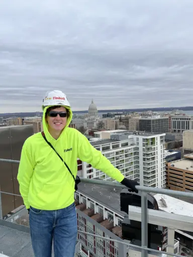 Colin Schiesl on top of the  ōLiv Madison apartments during construction.