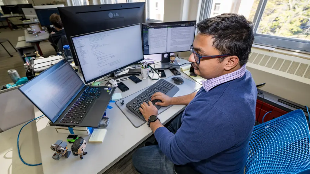 PhD student Asmit Nayak working at a computer
