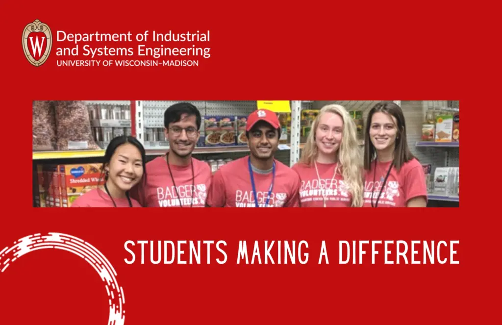 5 student volunteers standing in a row smiling