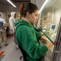Carley Schwartz works in a biosafety cabinet as part of Biomedical Engineering 602: CRISPR Genome Editing and Engineering Laboratory