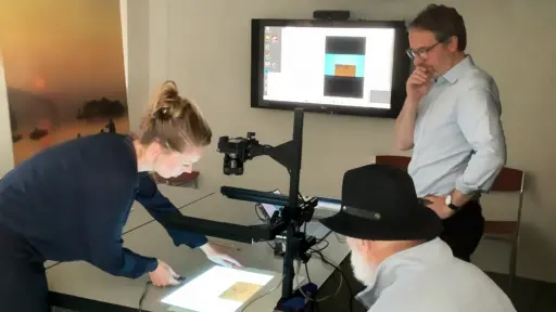 Marleen Ram places a drawing by Rembrandt under the watermark imaging system’s camera along with Rick Johnson and Rob Fucci