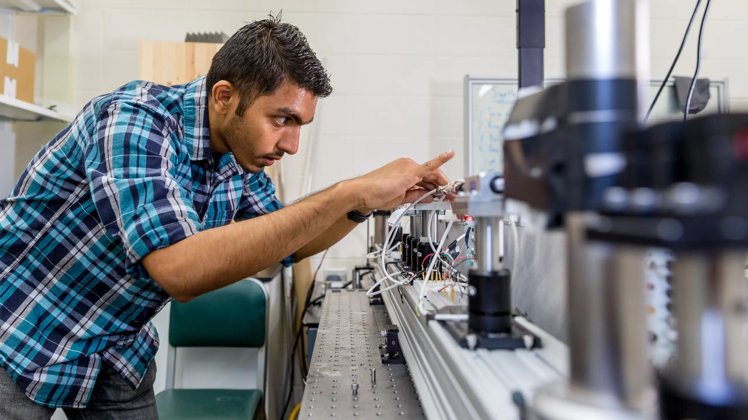 PhD student Bhanugoban Maheswaran tests the vertically aligned carbon nanotube foams in Assistant Professor Ramathasan Thevamaran's lab. Credit: Joel Hallberg.