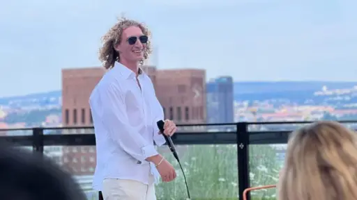 Alex Eichstaedt performing at a rooftop venue.