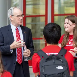 Ian Robertson talking with students