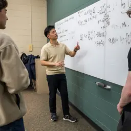 Kangwook Lee talking with students