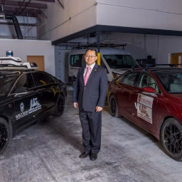 Xiaopeng Li with UW-Madison autonomous passenger vehicles