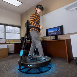 UW-Madison civil and environmental engineering PhD student Wei Han demonstrates a virtual reality system his group is using to research how drones affect construction worker safety on work sites
