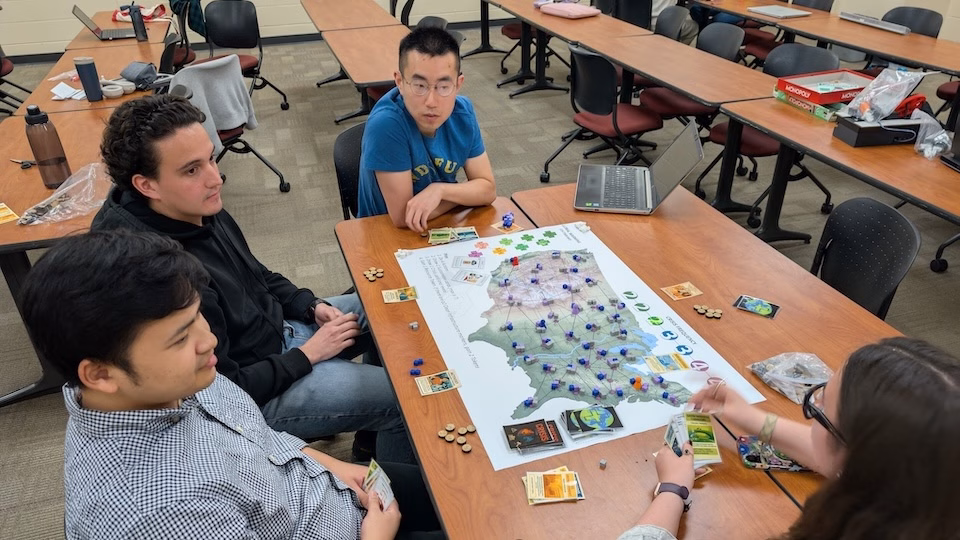 Students play an educational game that they created in the Engineering Sustainability: Linking Technology, Policy, Health and Economics course