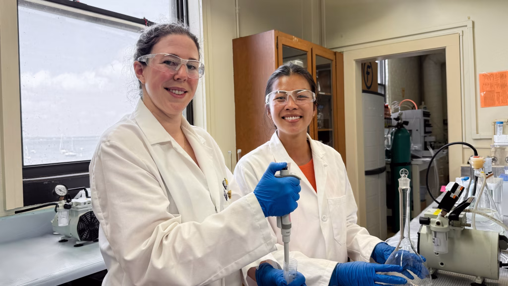PhD students Ali Milani and Kaitylyn Gruber working in the lab