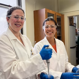 PhD students Ali Milani and Kaitylyn Gruber working in the lab