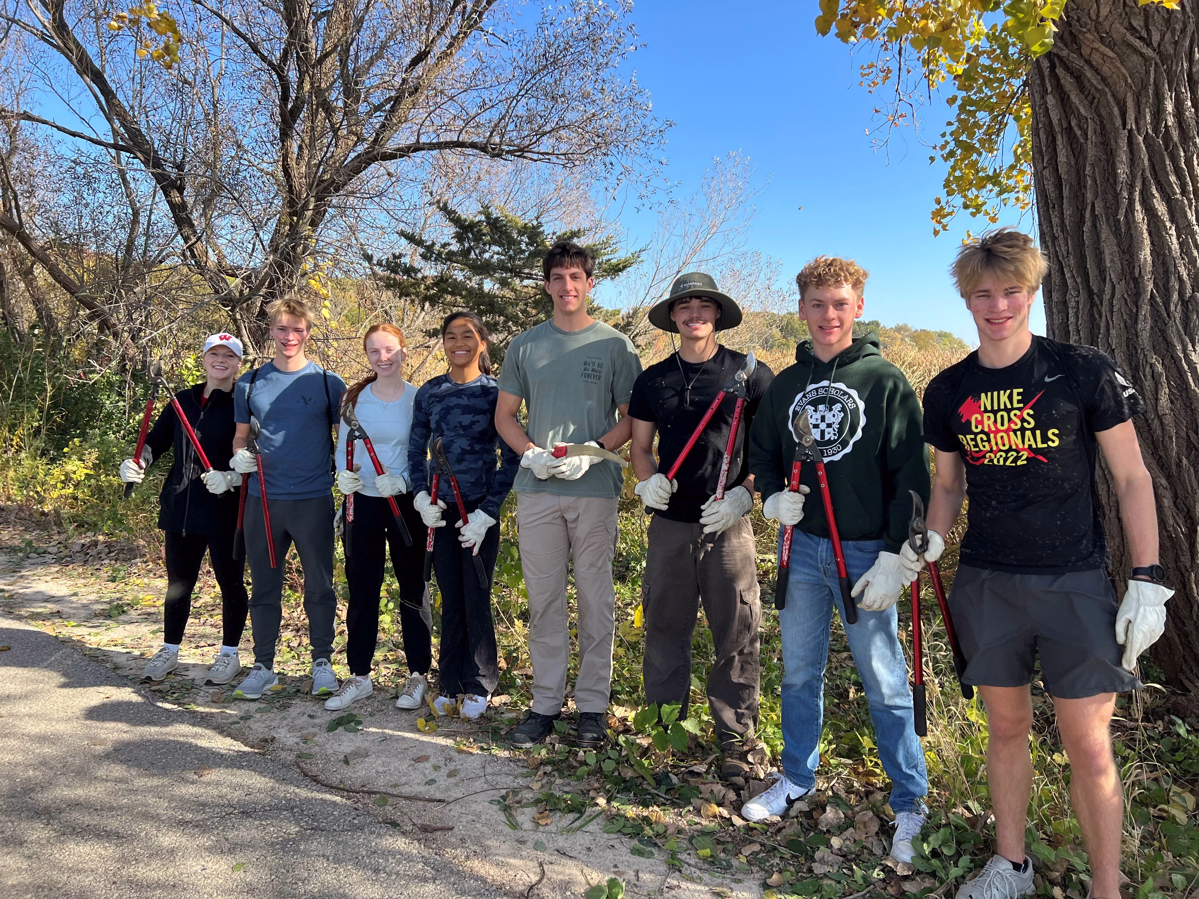 Group of students dressed casually standing in a park