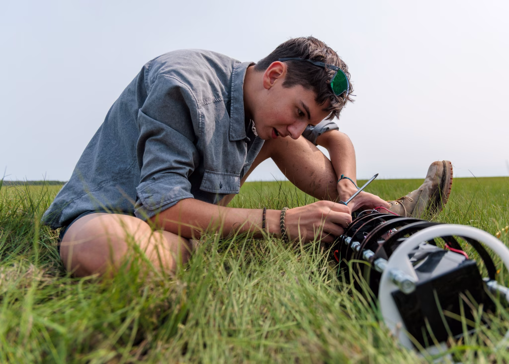 Soren Goldsmith checks on his camera in the field in Massachusetts