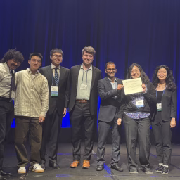 A group of students and a faculty advisor holding a certificate