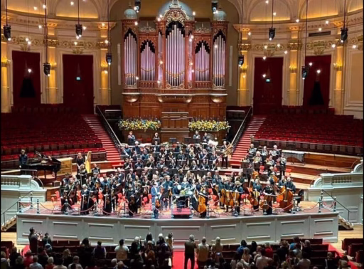 Wide shot of orchestra performing a concert with Madeline Bingenheimer.