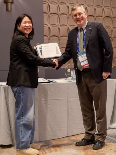 Minjeong Kim being presented a certificate