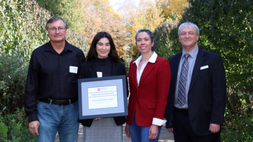 Riverview Terrace team members pose with their NCEES award outside on a sunny day.