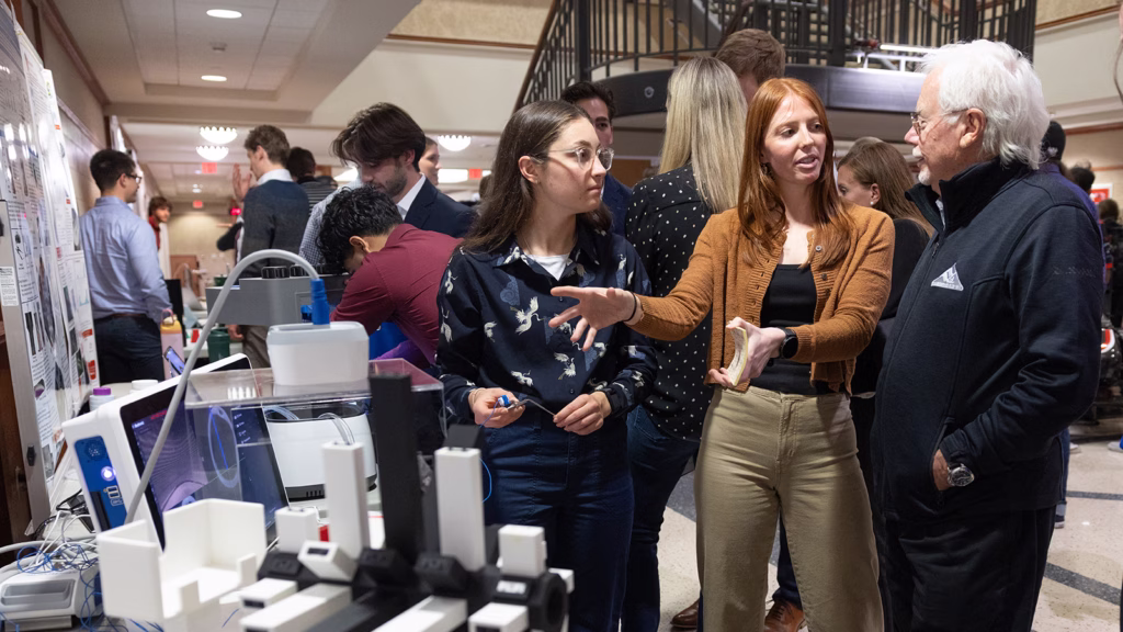 Mechanical engineering students talk with alumnus Bjorn Borgen during the department's spring design showcase