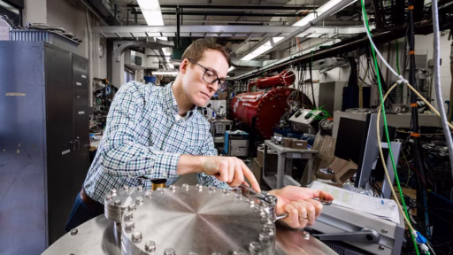Charlie Hirst works on equipment in the UW-Madison Ion Beam Laboratory