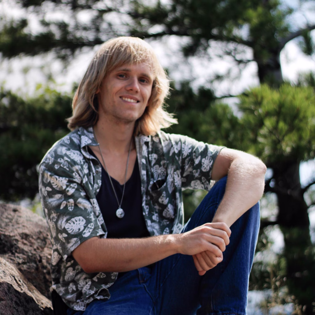 Christopher Barns smiles amidst a serene nature trail