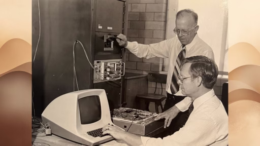Old photo of Donald Dietmeyer and colleague working at early generation computer