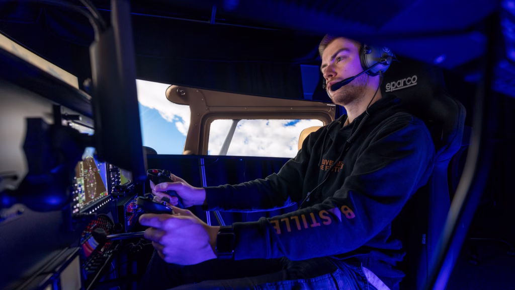 Teaching specialist Aidan Butula operates the new flight simulator