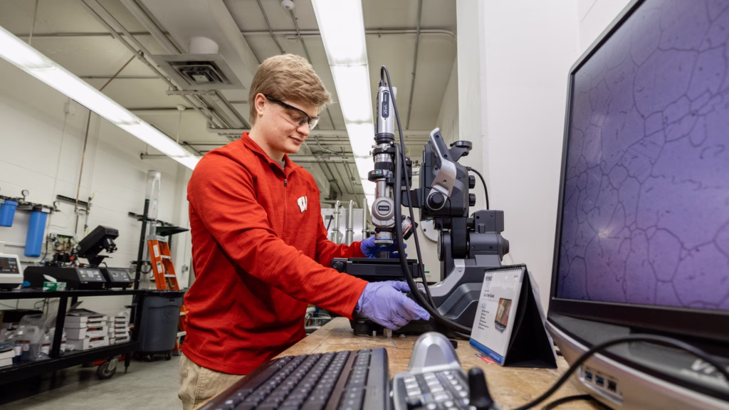 Lukas Desorcy takes a microscope image of a diffusion welded sample