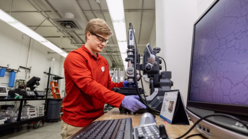 Lukas Desorcy takes a microscope image of a diffusion welded sample