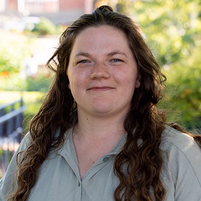 Profile photo of Abigail Cordiner. She has long brown hair and is wearing a gray button up.
