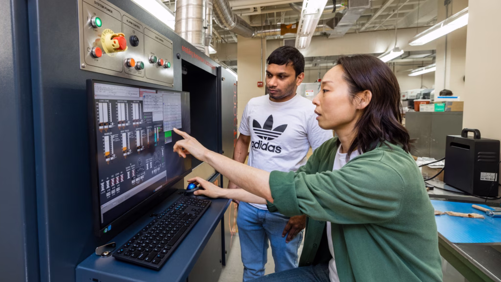 Postdoctoral researcher Ara Kim and graduate student Lasantha Weerasekara use the new chemical vapor deposition system